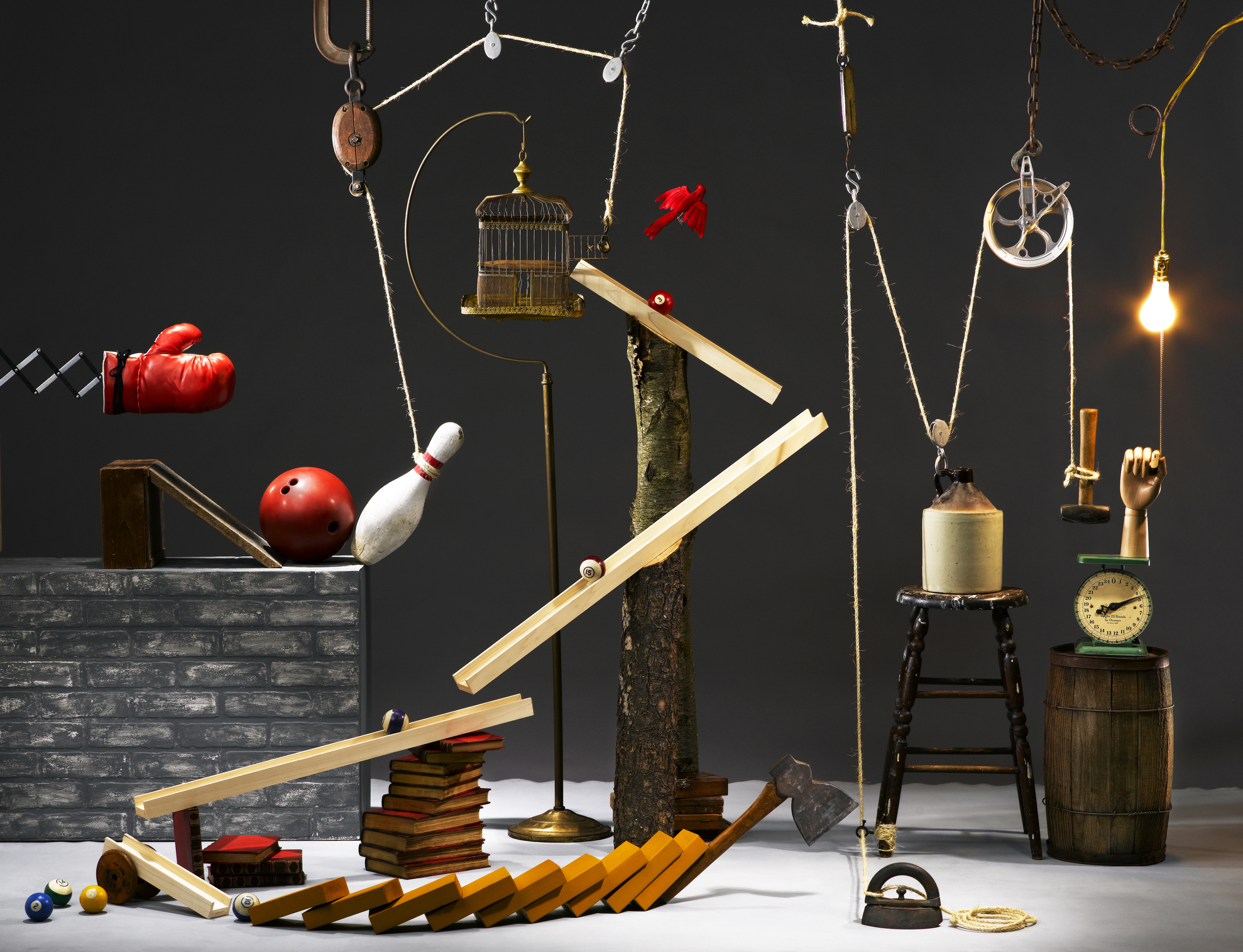 An image of a rube goldberg machine with a gray background 
